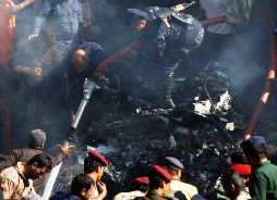 Army and police officers work at the scene of a plane crash in Sanaa, Yemen, Wednesday, Nov. 21, 2012. Yemeni security officials say a military plane has crashed during training over the capital, Sanaa, killing all 10 people on board. Photo: Hani Mohammed / AP 