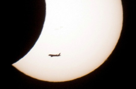 A plane flies in front of the world's first partial solar eclipse of 2011 on January 4, 2011 in Aachen, western Germany. A solar eclipse happens when the Moon swings between the Earth and the Sun. //DIRK BEBA/AFP/Getty Images